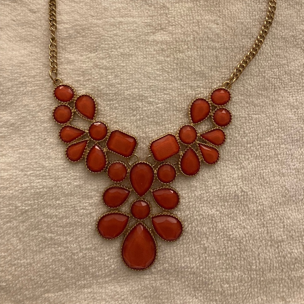 Great piece!! Fun to wear with a strapless dress, more of a peach or coral color